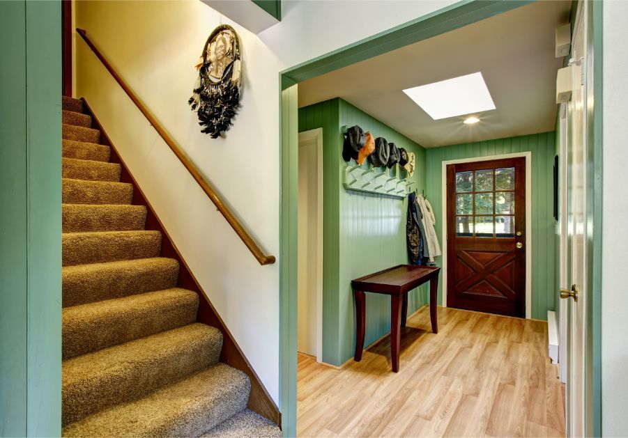 green foyer with staircase