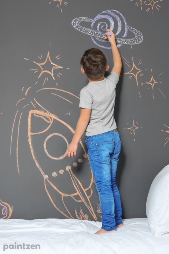 kid drawing chalk wall