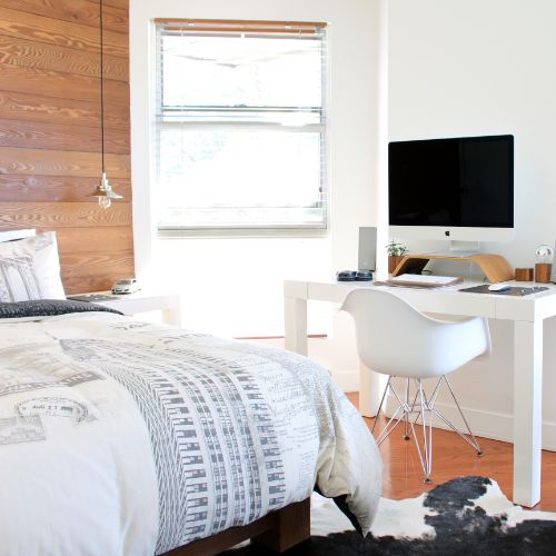 white guest bedroom with desk