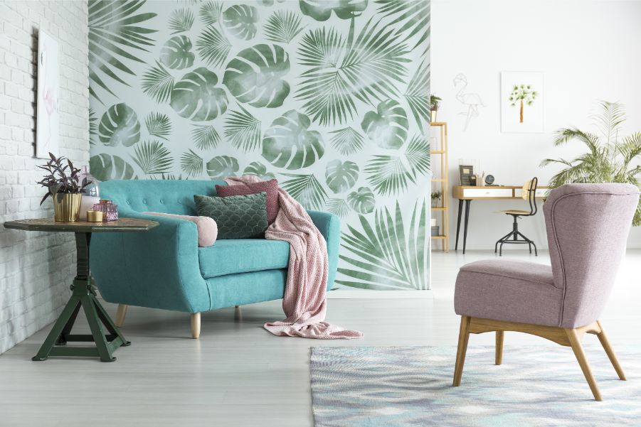 blue couch with botanical wallpaper