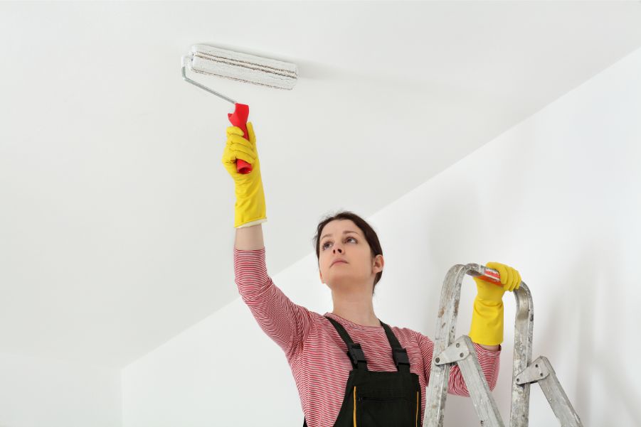 person painting ceiling