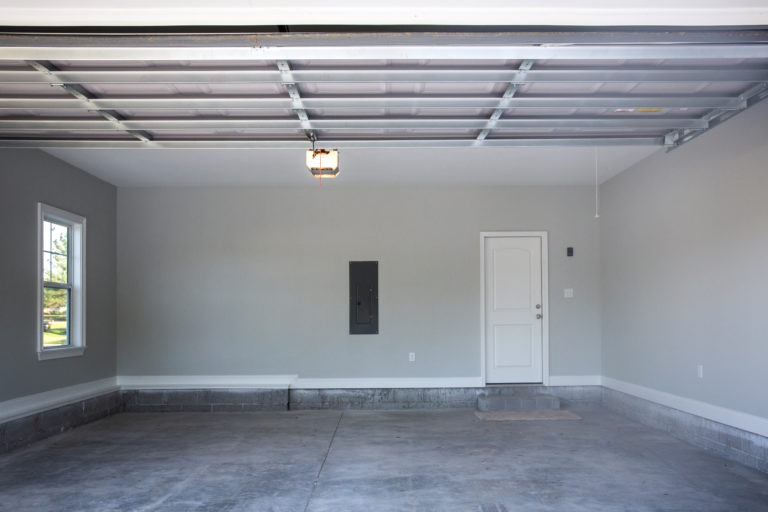 Empty large two-car garage with fresh paint