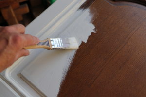 paint being applied to cabinet